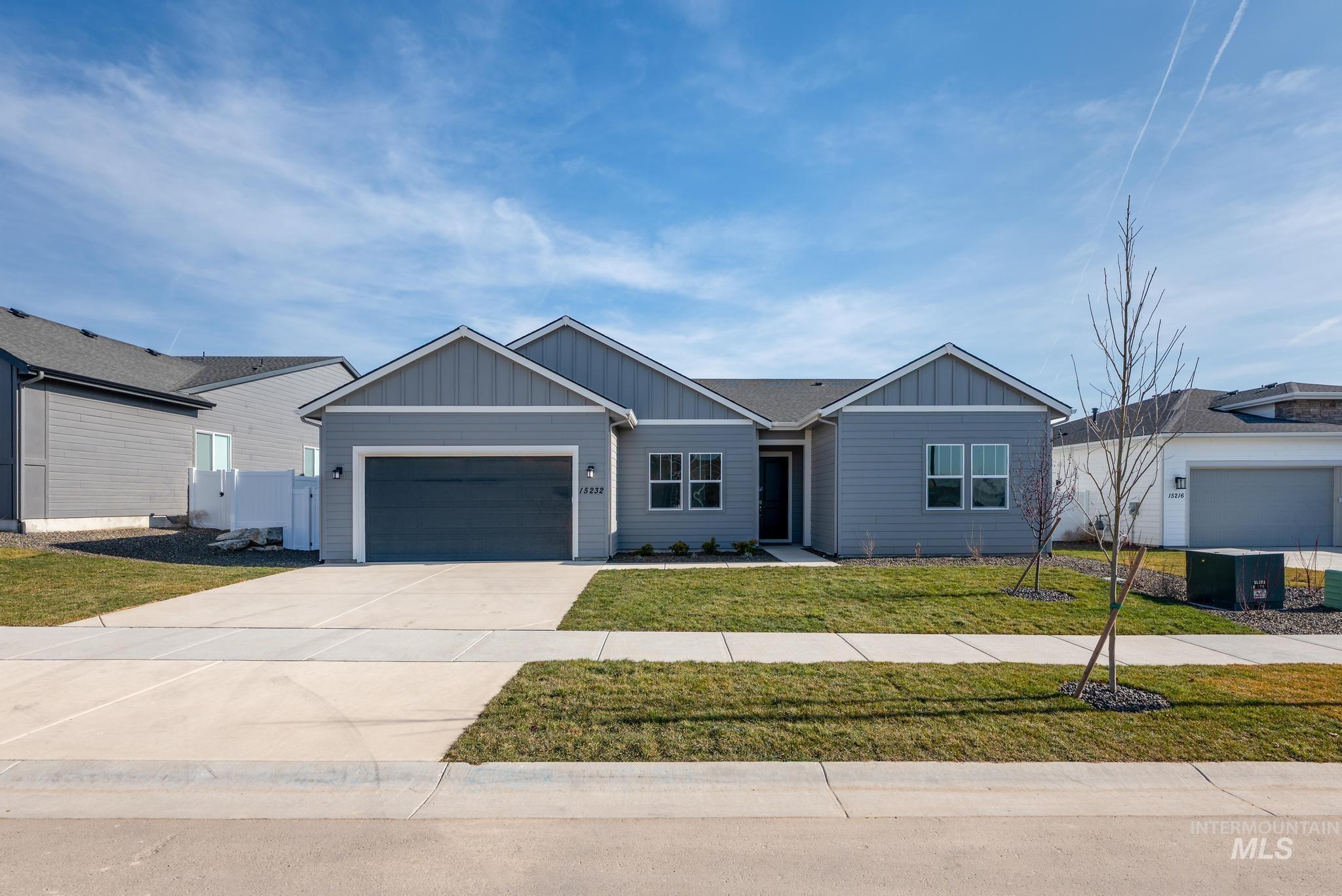 15232 Steel Cloud Avenue Caldwell, ID 83607 - Photo 1 of 33 Single story home featuring board and batten siding, driveway, a front lawn, an attached garage, and a gate
