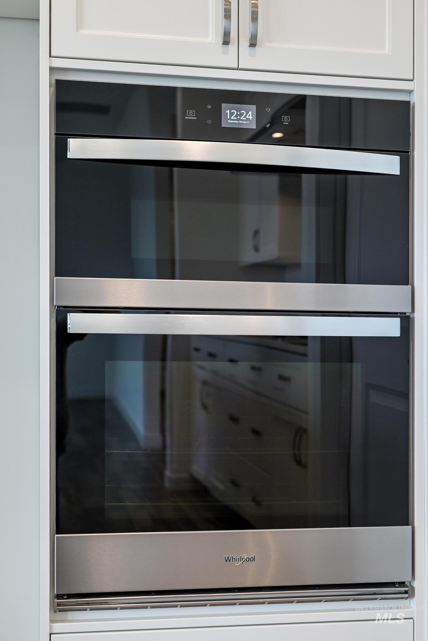15232 Steel Cloud Avenue Caldwell, ID 83607 - Photo 11 of 33 Kitchen view of stainless steel double oven and white cabinetry