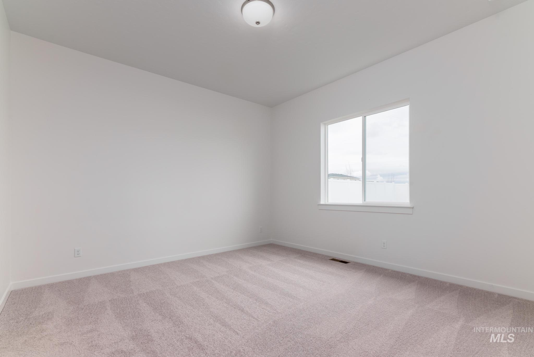 15232 Steel Cloud Avenue Caldwell, ID 83607 - Photo 16 of 33 Unfurnished room with light colored carpet and baseboards