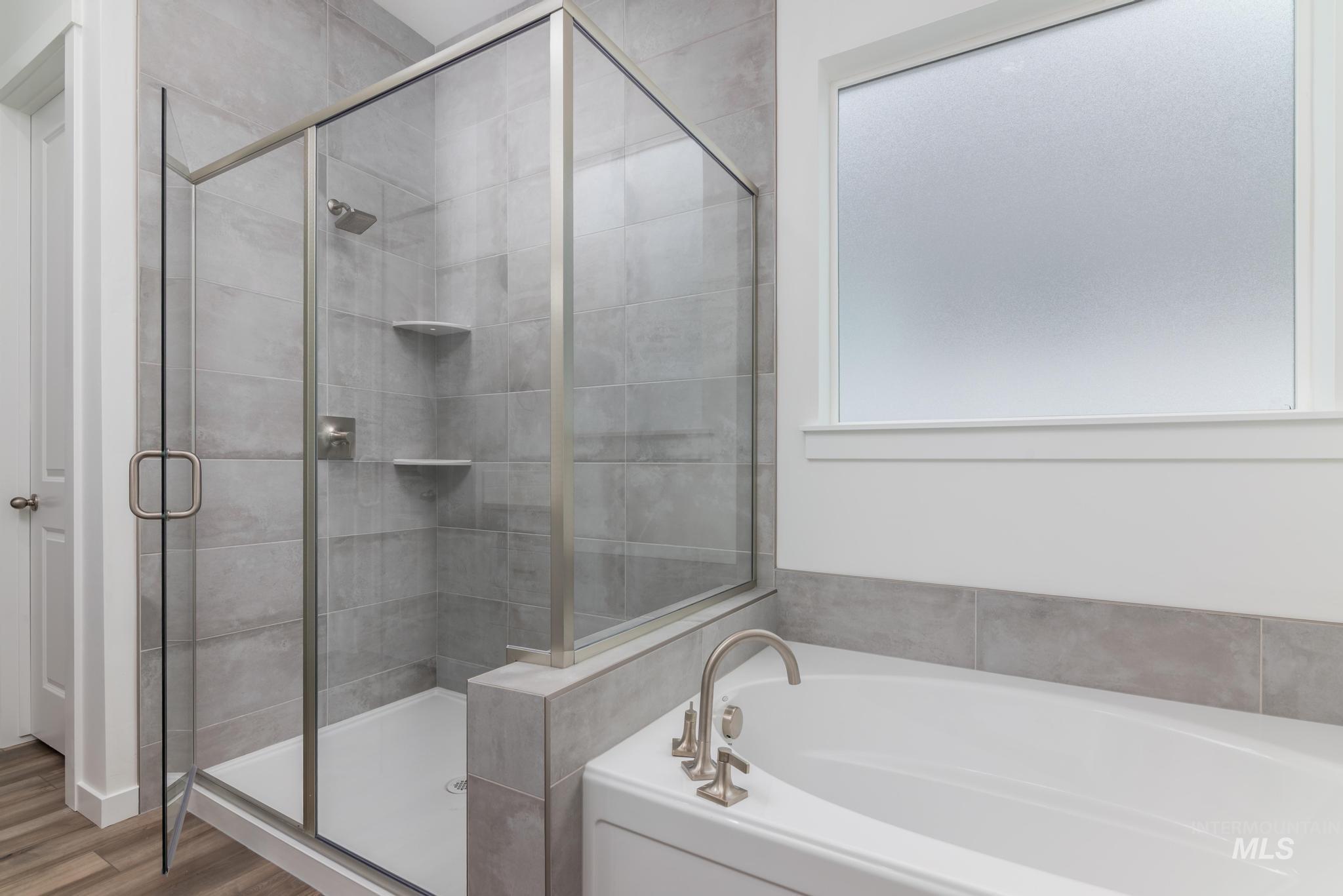15232 Steel Cloud Avenue Caldwell, ID 83607 - Photo 19 of 33 Bathroom featuring a garden tub and a stall shower