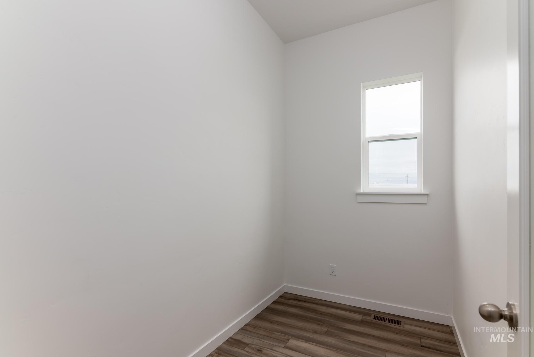 15232 Steel Cloud Avenue Caldwell, ID 83607 - Photo 20 of 33 Spare room with wood finished floors and baseboards