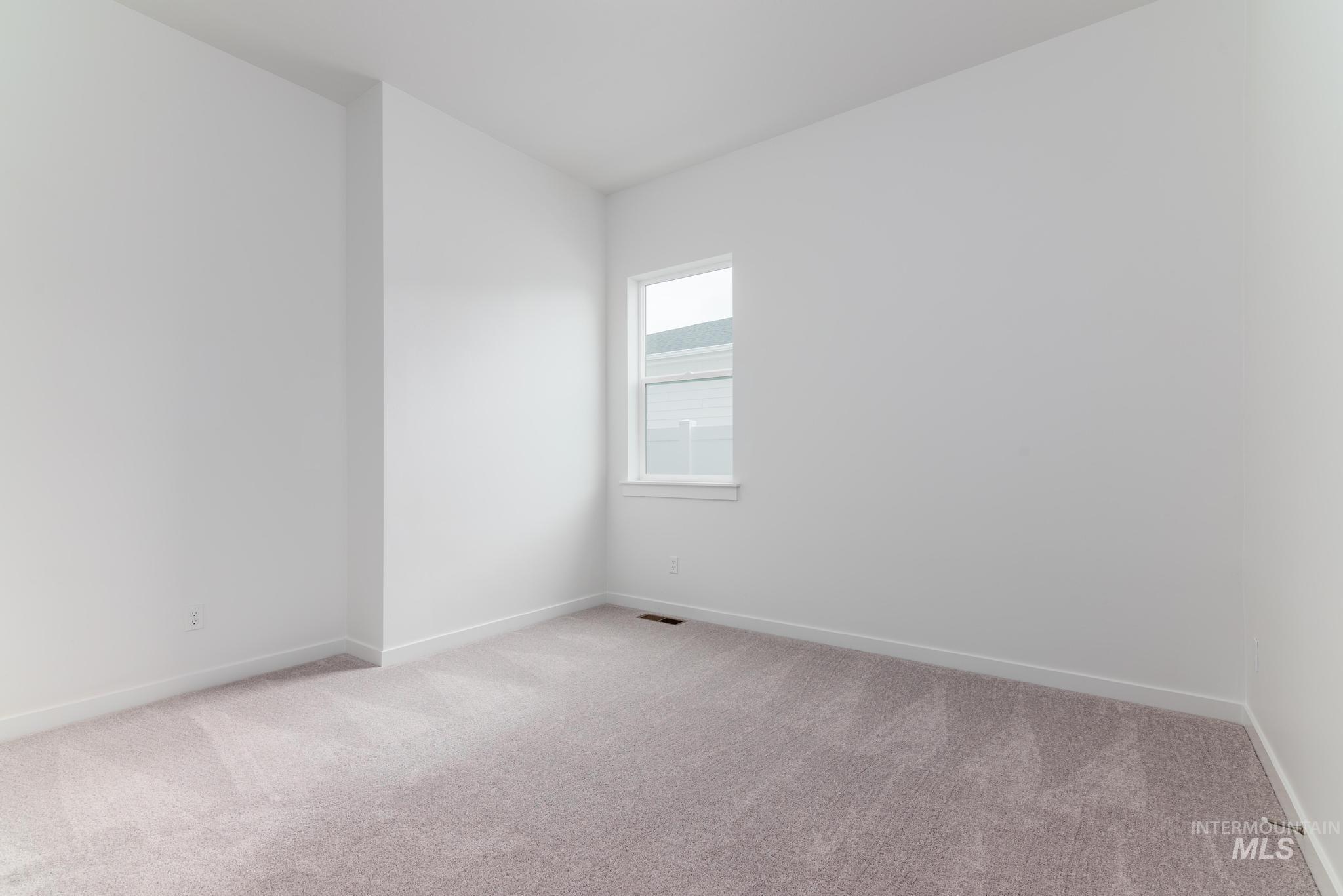 15232 Steel Cloud Avenue Caldwell, ID 83607 - Photo 23 of 33 Empty room with light carpet and baseboards