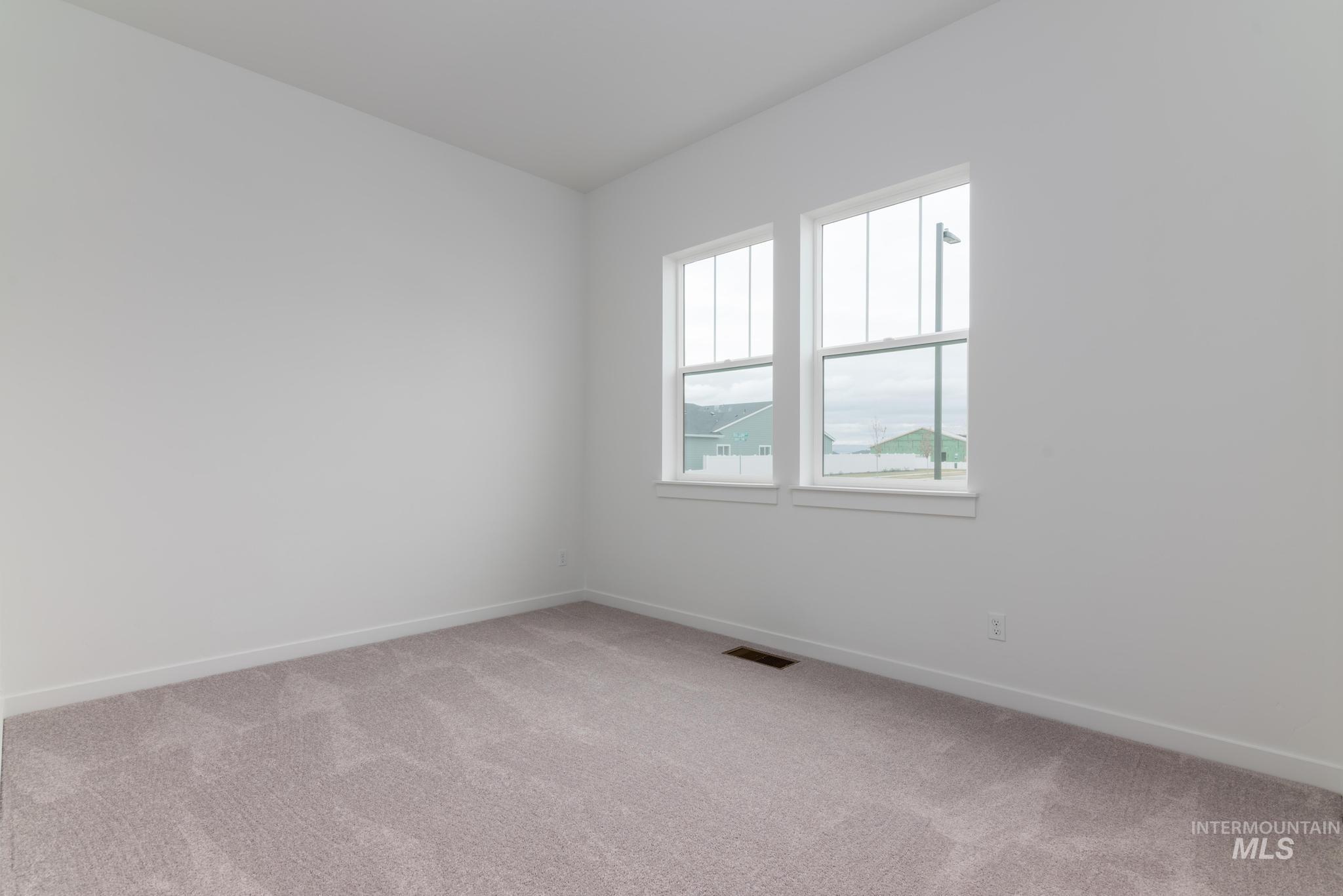 15232 Steel Cloud Avenue Caldwell, ID 83607 - Photo 24 of 33 Spare room with light colored carpet and baseboards