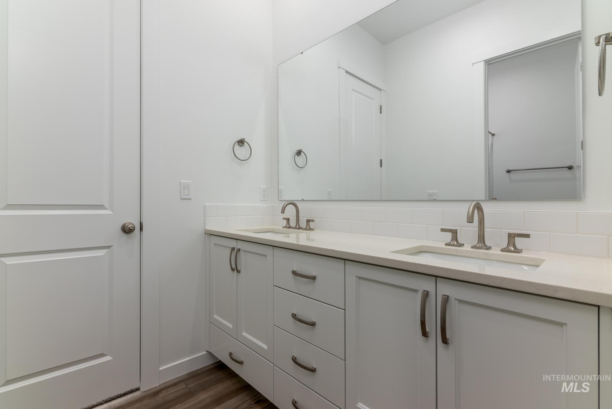 15232 Steel Cloud Avenue Caldwell, ID 83607 - Photo 25 of 33 Bathroom with double vanity and dark wood-style floors