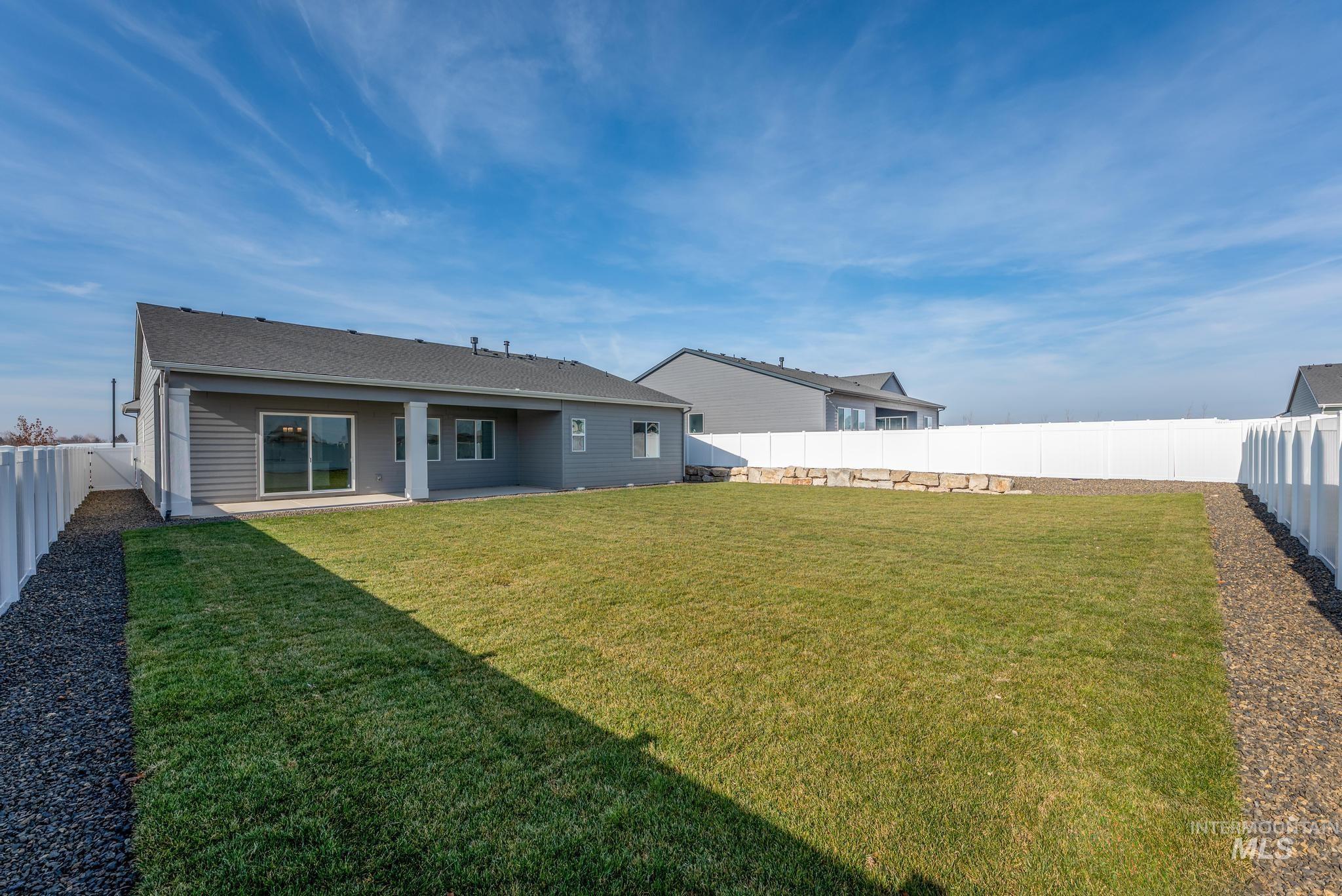 15232 Steel Cloud Avenue Caldwell, ID 83607 - Photo 29 of 33 Back of property featuring a fenced backyard and a patio area