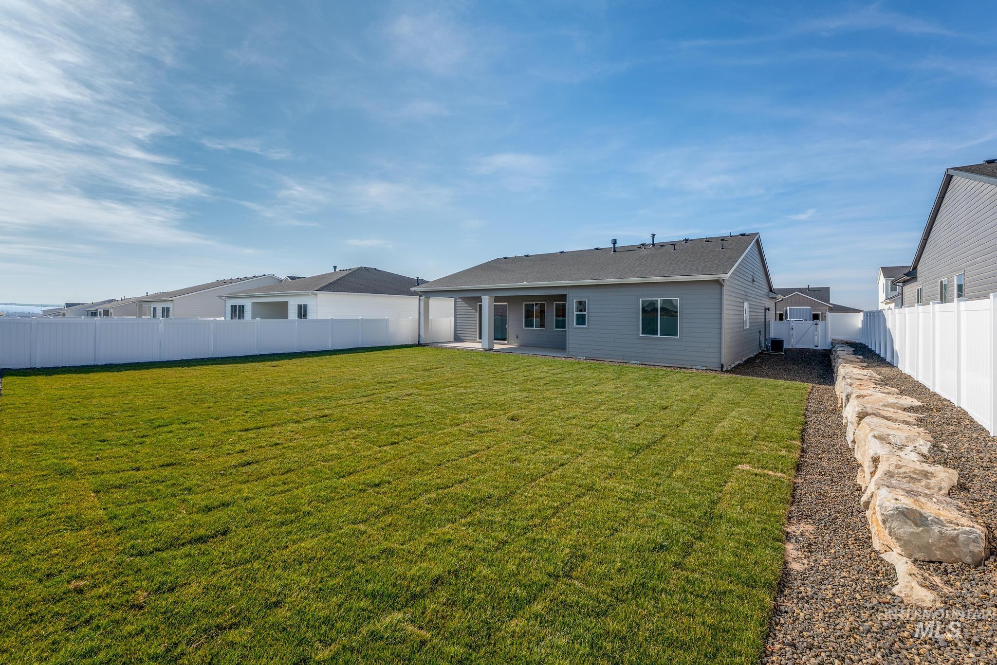 15232 Steel Cloud Avenue Caldwell, ID 83607 - Photo 30 of 33 Back of property with a patio and a fenced backyard
