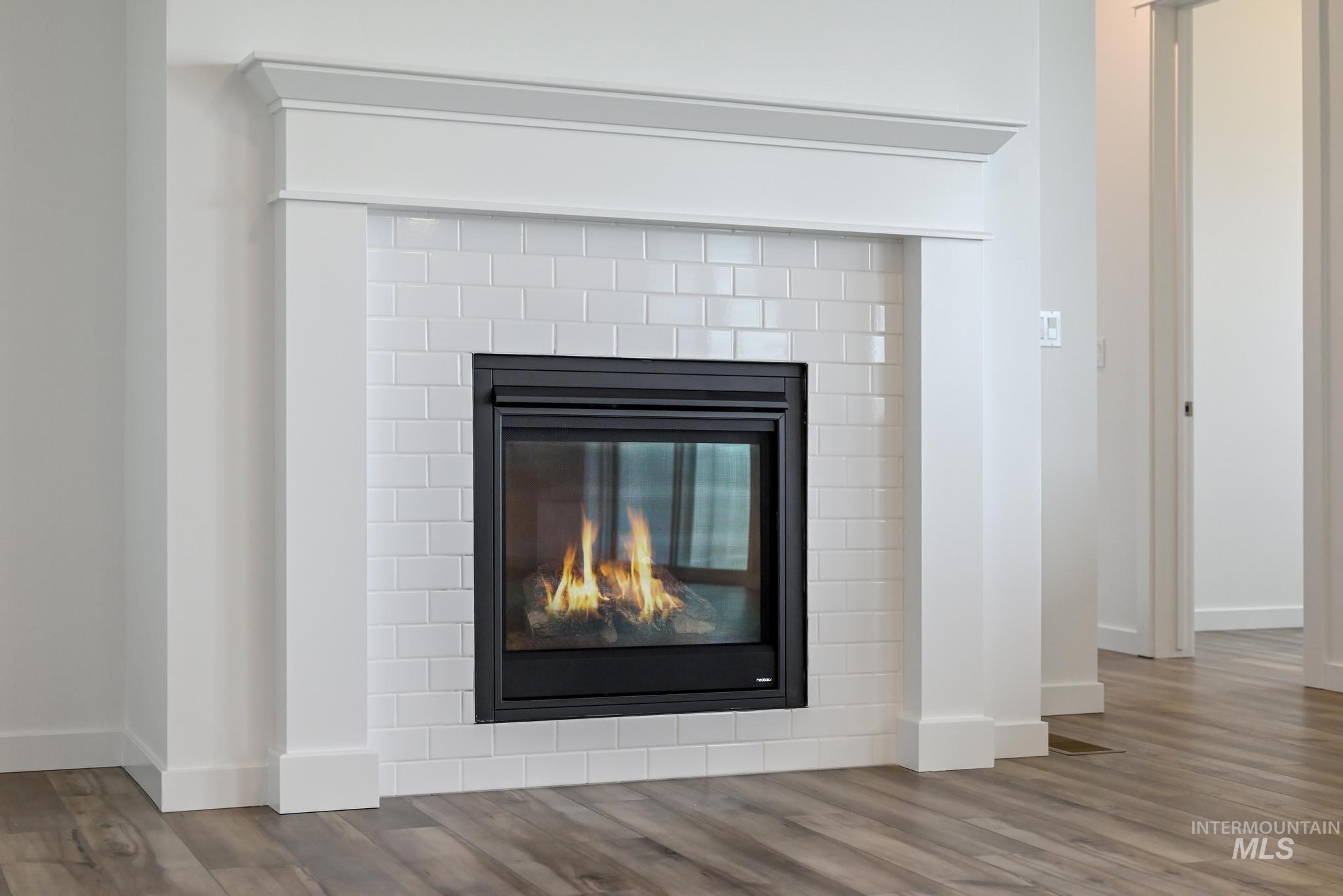 15232 Steel Cloud Avenue Caldwell, ID 83607 - Photo 6 of 33 Detailed view of a glass covered fireplace and wood finished floors