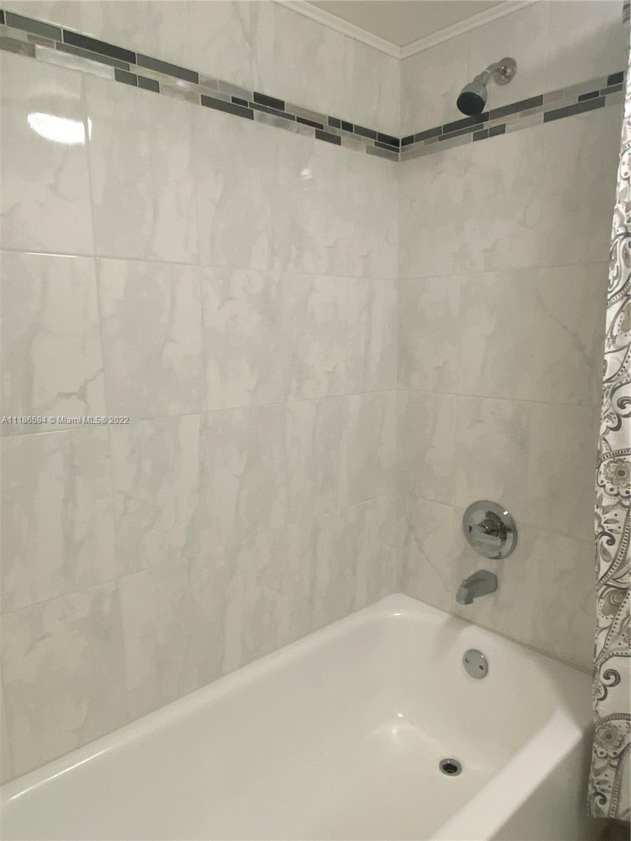 360 Racquet Club Road, Unit 201 Weston, FL 33326 - Photo 3 of 6 a bathroom with a bathtub and a shower
