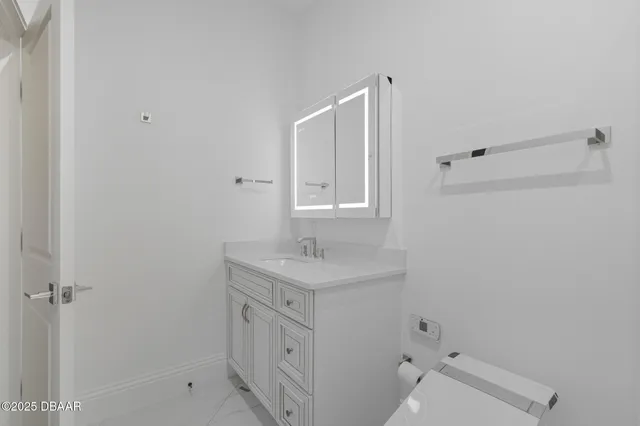 a view of a dining room with furniture and a chandelier