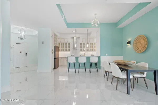 a kitchen with a dining table chairs stove and cabinets