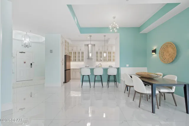 a kitchen with a dining table chairs stove and cabinets