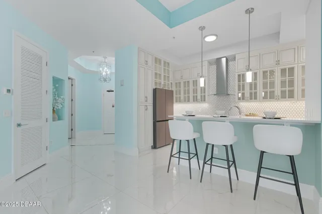 a kitchen with stainless steel appliances granite countertop white cabinets and a stove