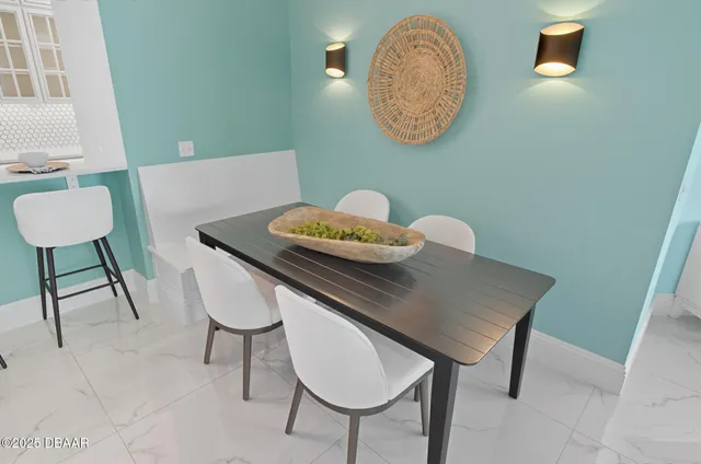 a bedroom with a bed lamp and a large window