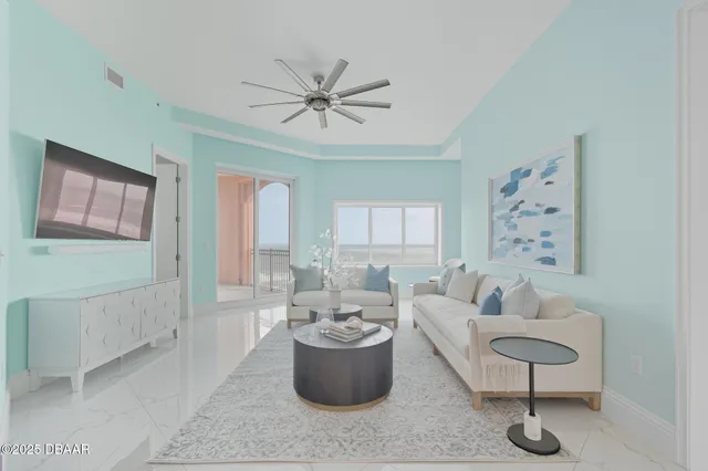 a bedroom with a bed a flat screen tv and a chandelier