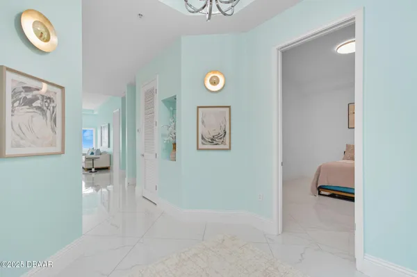 a view of a hallway to a livingroom with furniture and workspace