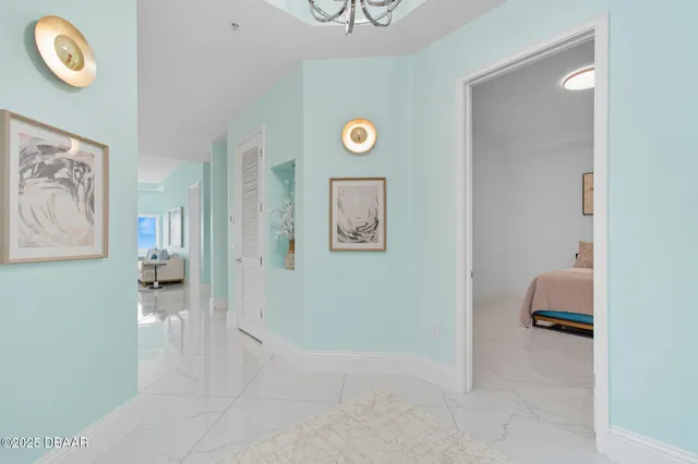 a view of a hallway to a livingroom with furniture and workspace