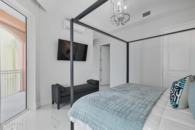 a bedroom with a bed painting and a window