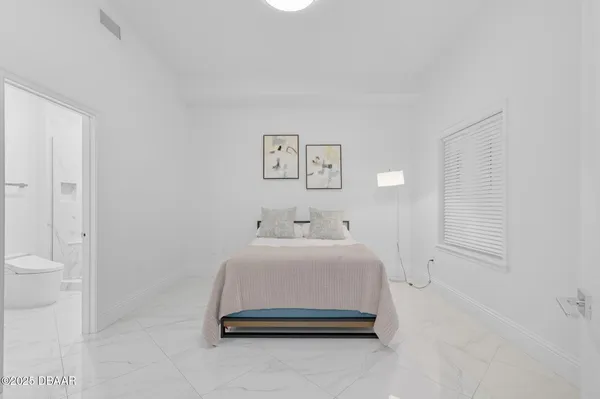 a bedroom with a bed and a couch