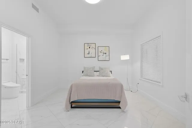 a bedroom with a bed and a couch