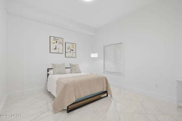 a bedroom with a bed and a wall painting