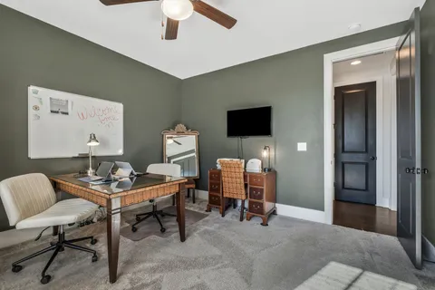 a spacious bedroom with a bed and a flat screen tv