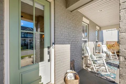 a front view of a house with outdoor seating