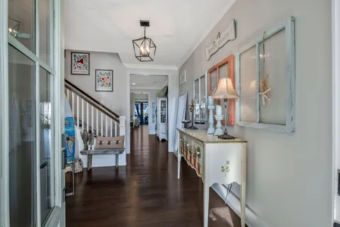 a view of a room with wooden floor and furniture