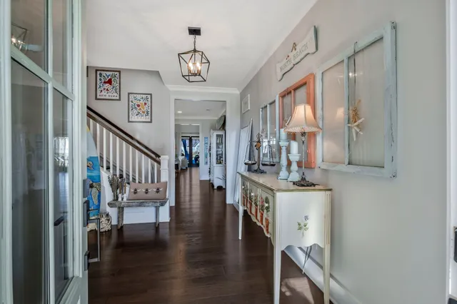 a view of a room with wooden floor and furniture