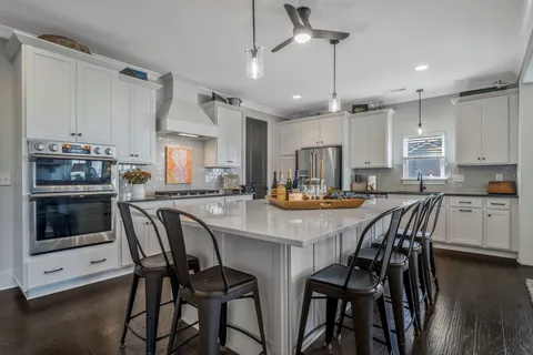 a kitchen with white cabinets and stainless steel appliances