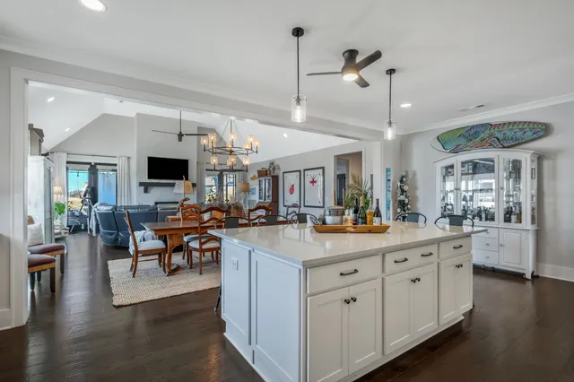 a kitchen with stainless steel appliances a table chairs refrigerator and microwave