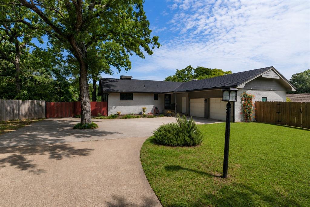 205 Timberlake Drive Azle, TX 76020 - Photo 2 of 40 a front view of a house with a yard