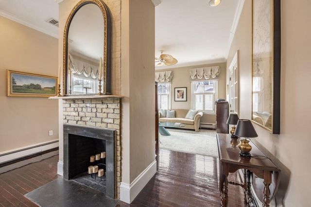 a view of living room with furniture and a fireplace