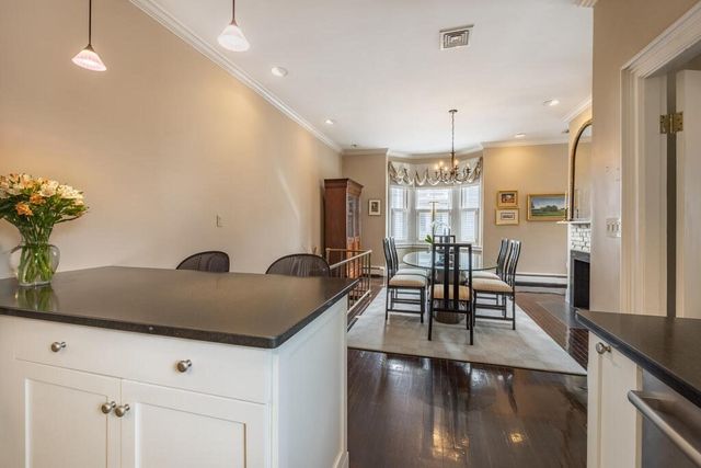 a dining room with furniture a rug and wooden floor