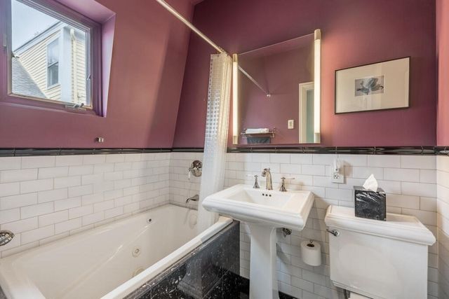 a view of a hallway with wooden floor and entryway