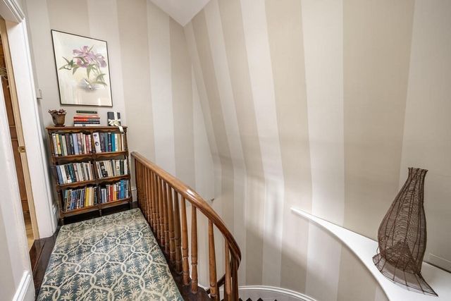 a view of a hallway with a livingroom and a bathroom
