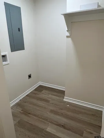 a view of a small space with wooden floor and a window