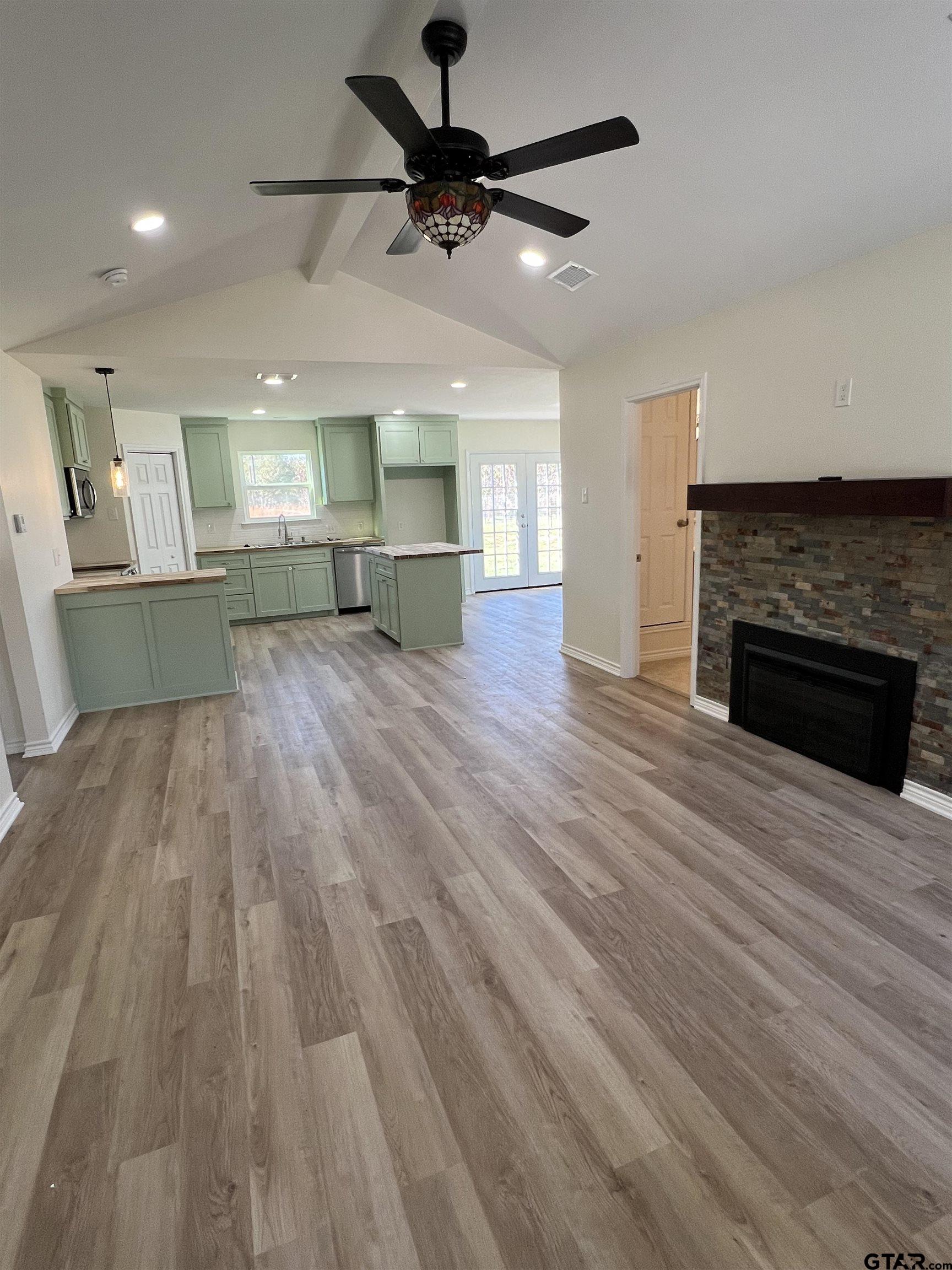 125 Pecan Drive Bullard, TX 75757 - Photo 4 of 16 a view of empty room with wooden floor and fireplace