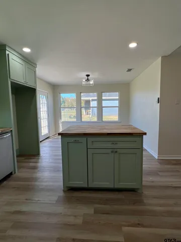 a kitchen with a sink and a mirror