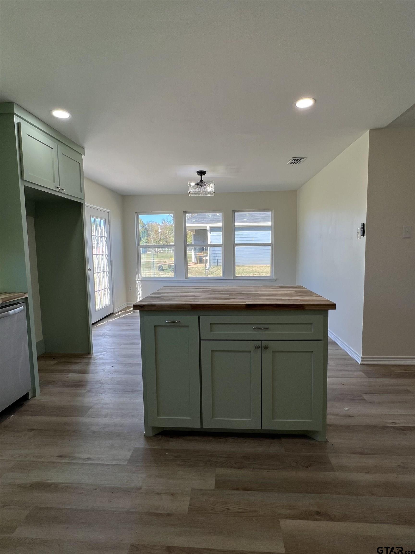 125 Pecan Drive Bullard, TX 75757 - Photo 7 of 16 a kitchen with a sink and a mirror