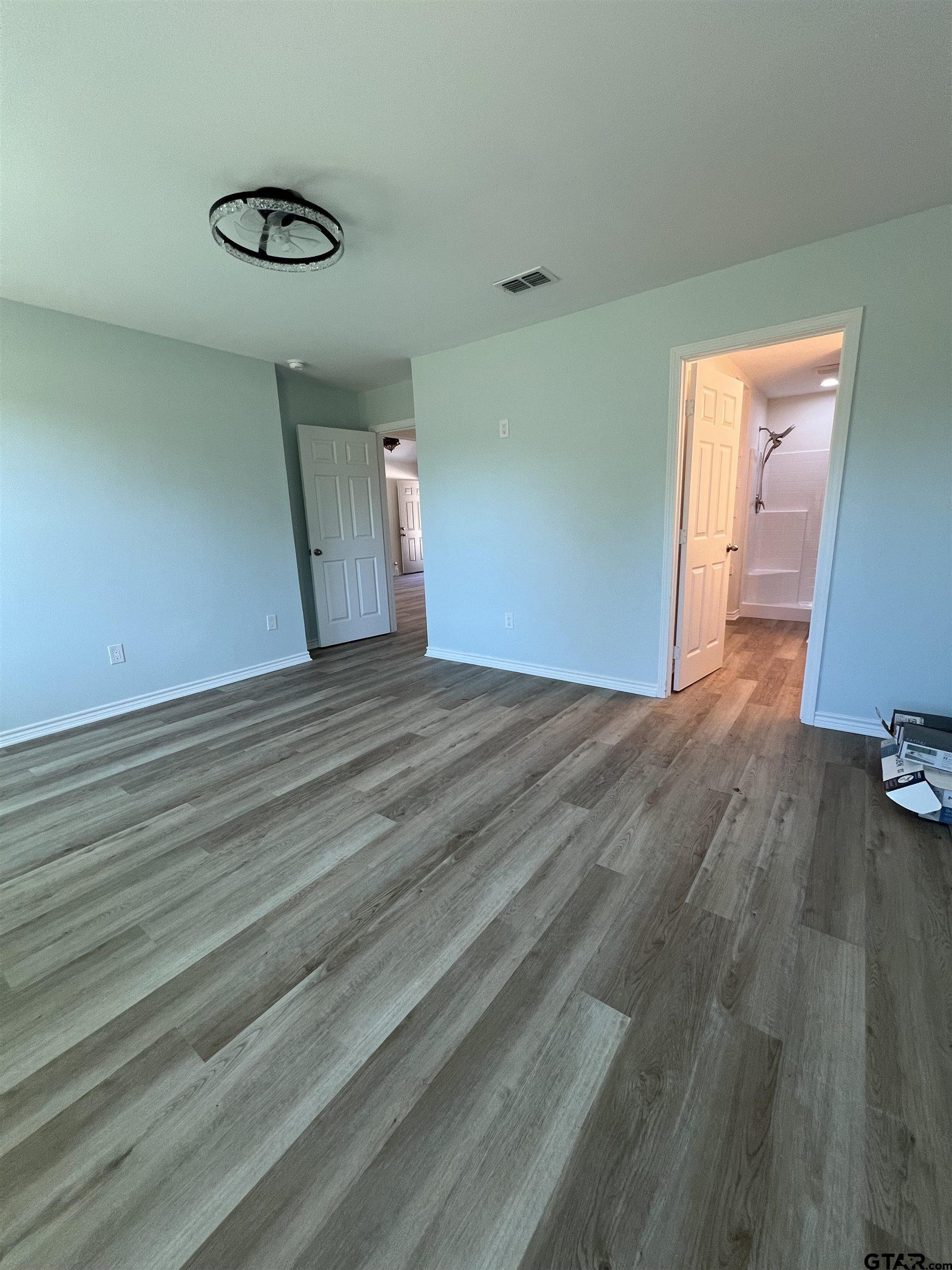 125 Pecan Drive Bullard, TX 75757 - Photo 9 of 16 a view of an empty room with wooden floor and a window