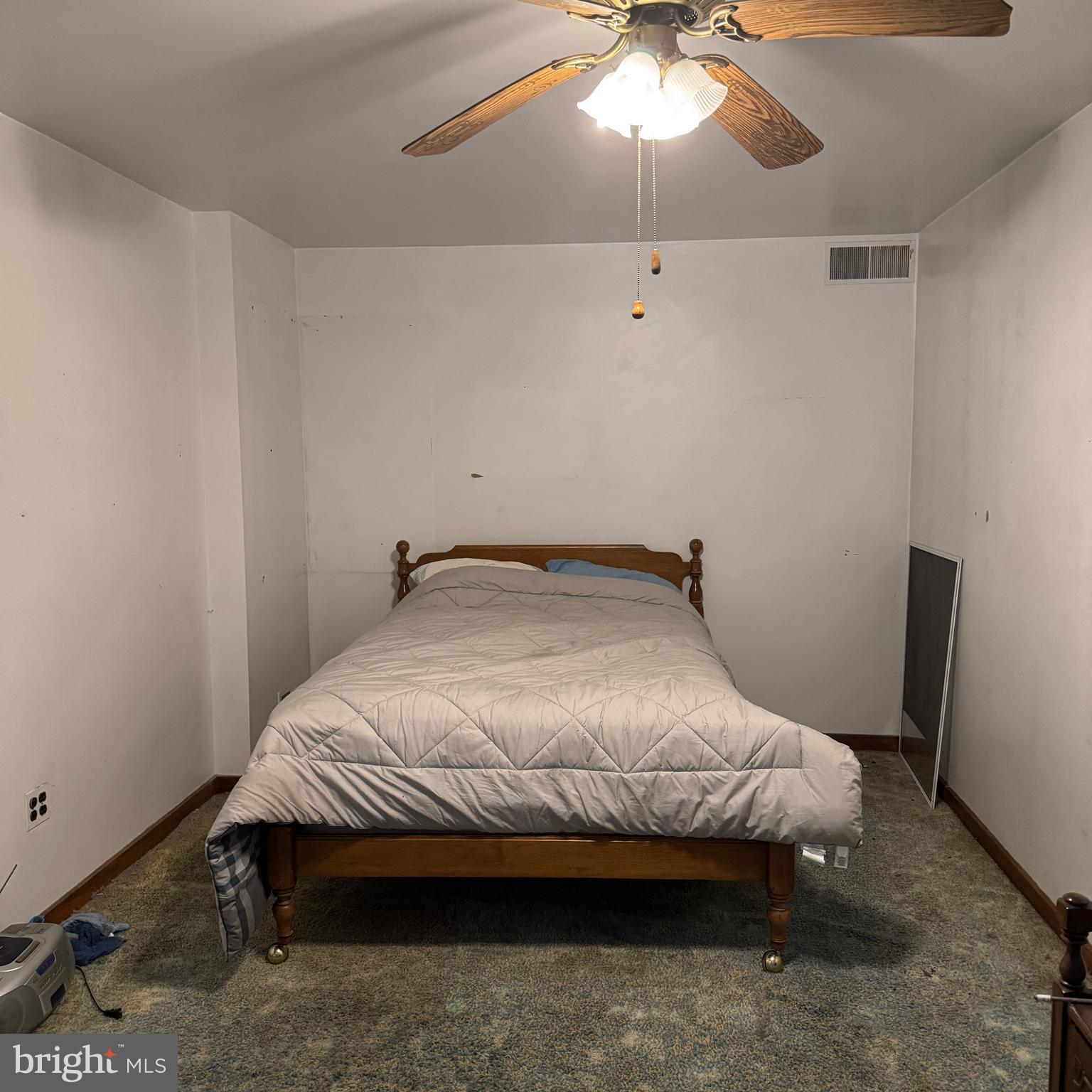 407 Willow Road Oreland, PA 19075 - Photo 13 of 30 a bedroom with a bed and a chandelier