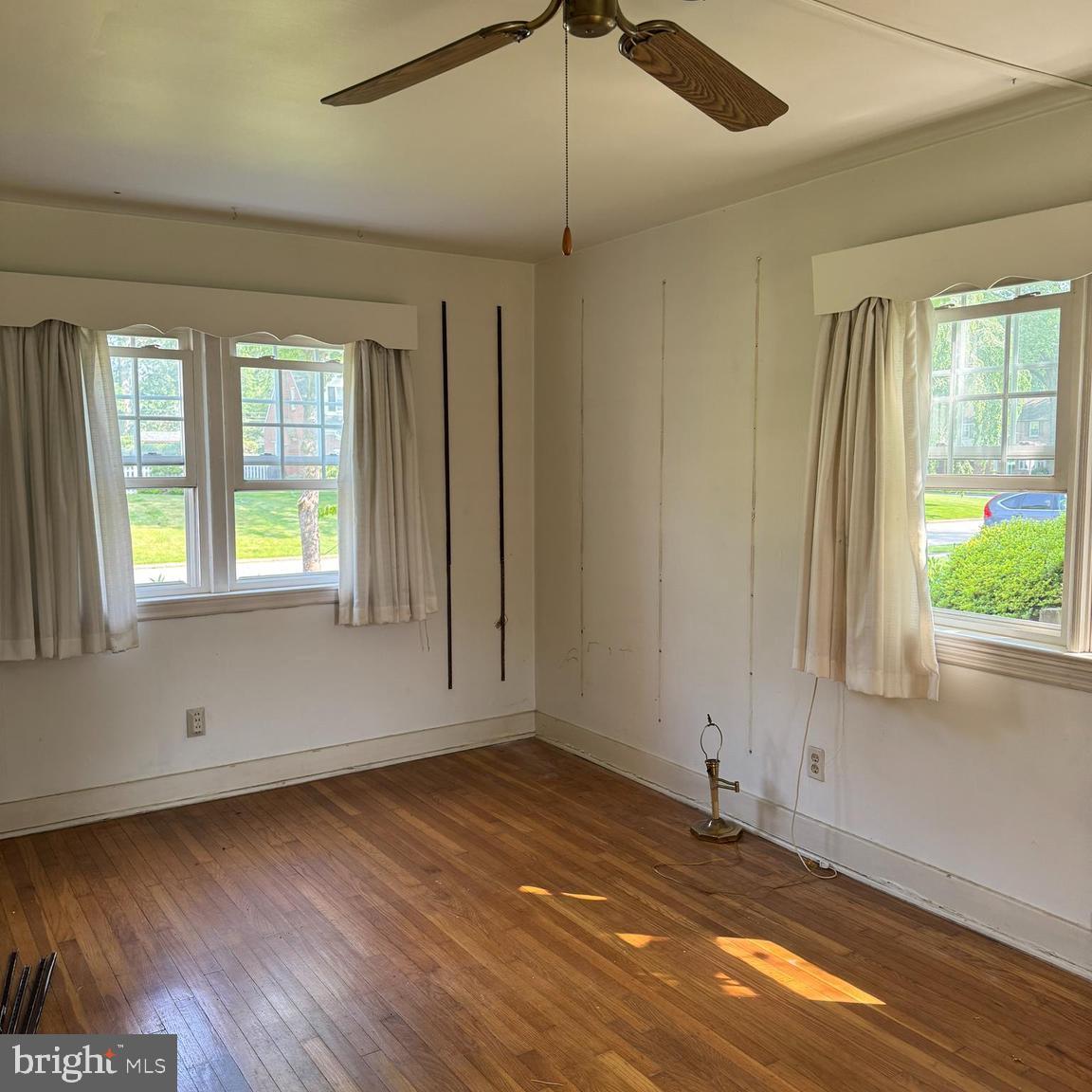 407 Willow Road Oreland, PA 19075 - Photo 14 of 30 an empty room with wooden floor and windows