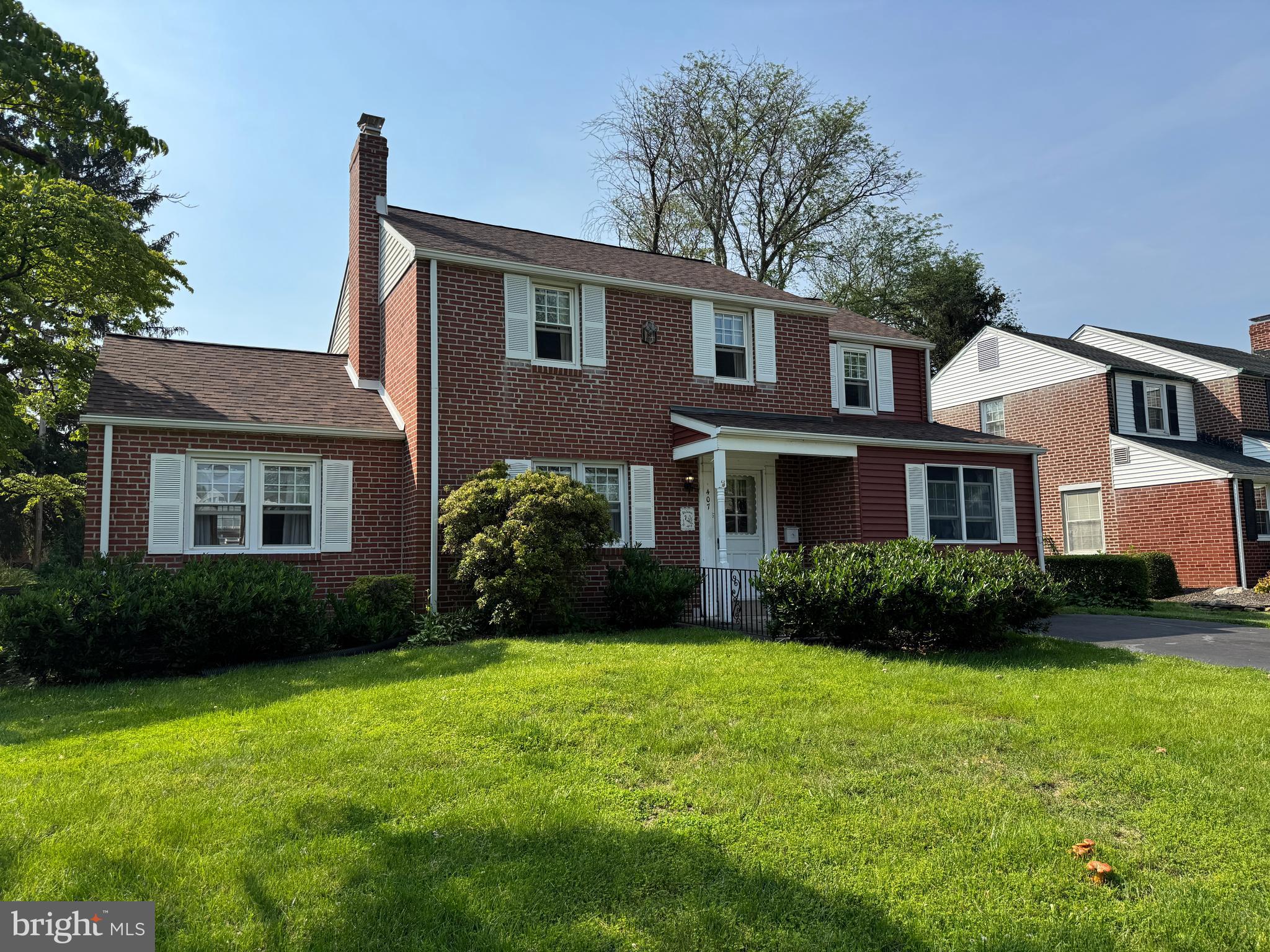 407 Willow Road Oreland, PA 19075 - Photo 2 of 30 a front view of a house with a garden