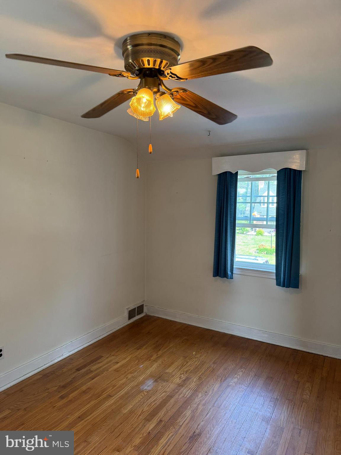 407 Willow Road Oreland, PA 19075 - Photo 21 of 30 an empty room with wooden floor and windows