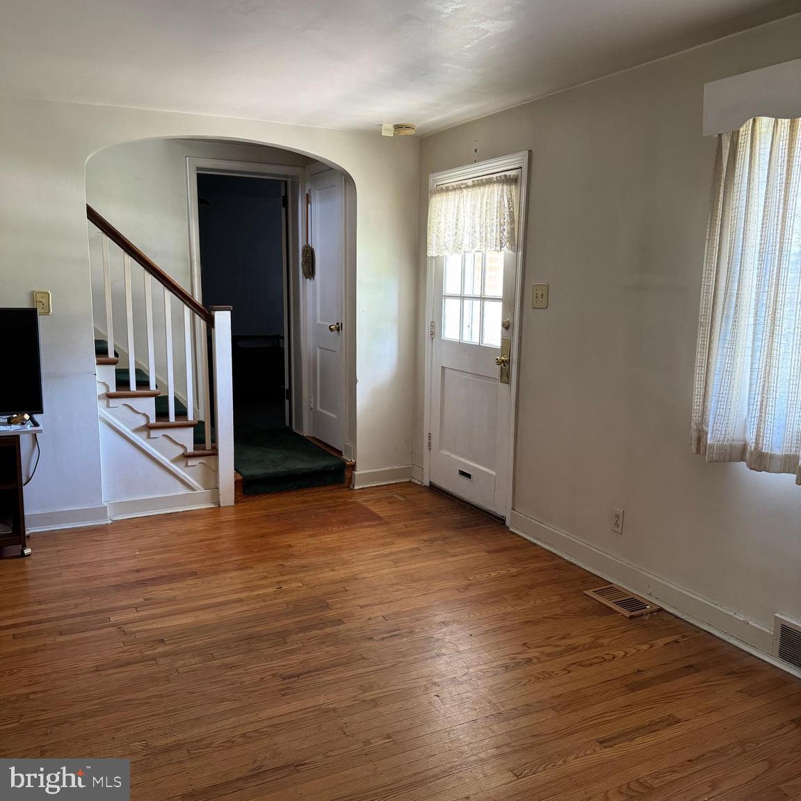 407 Willow Road Oreland, PA 19075 - Photo 5 of 30 an empty room with wooden floor and windows