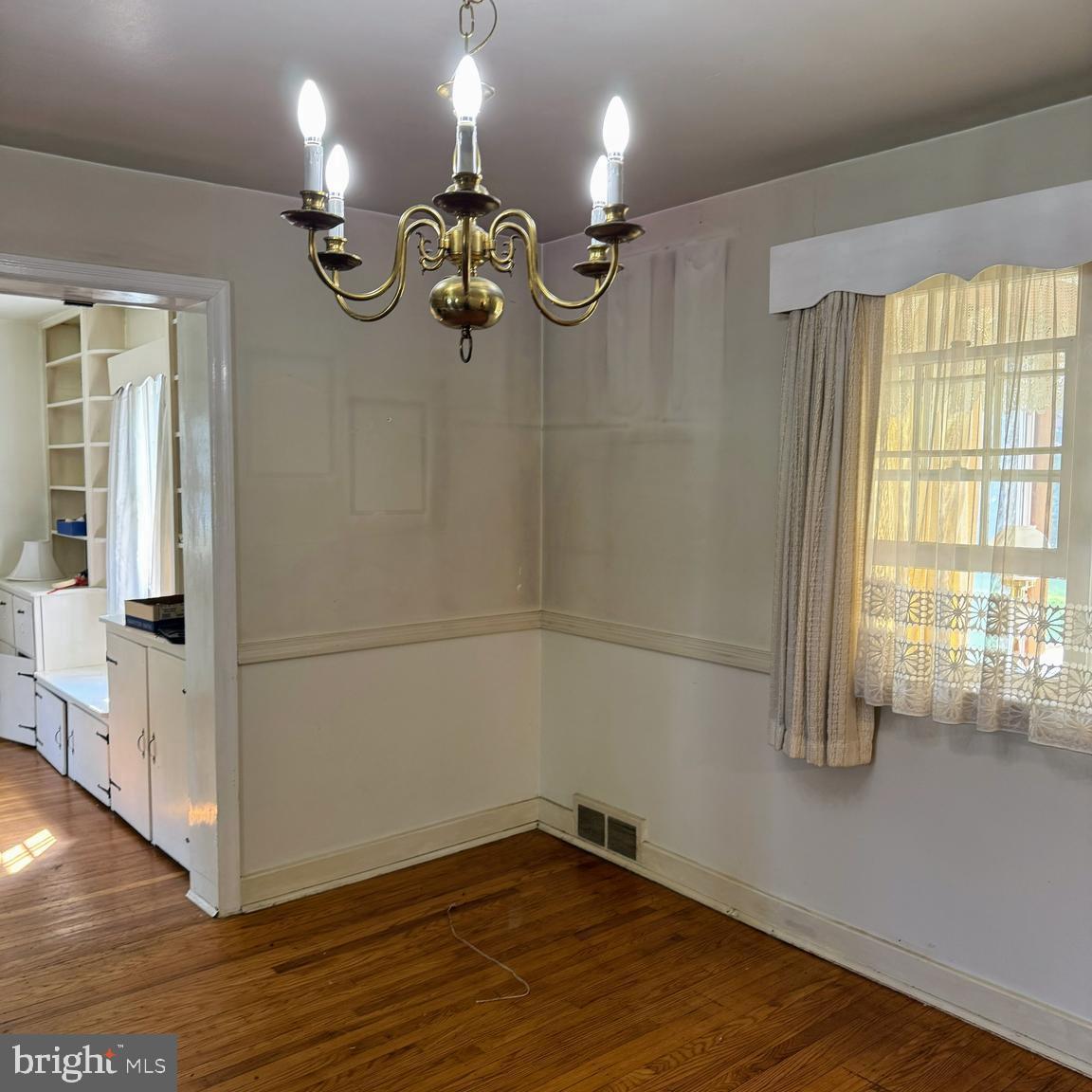 407 Willow Road Oreland, PA 19075 - Photo 7 of 30 wooden floor in an empty room with a window
