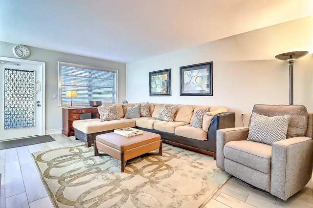 a living room with furniture and a potted plant