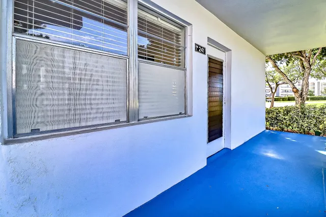 a view of a room with wooden floor and a window