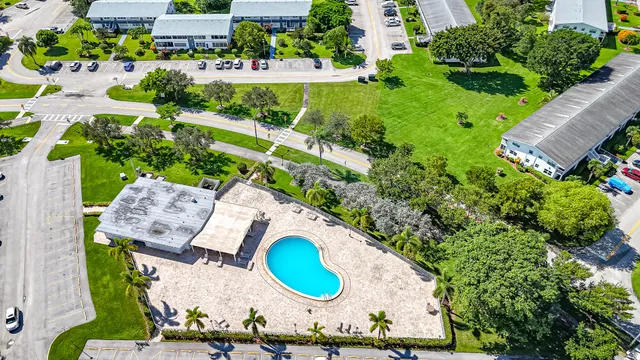an aerial view of a house with garden space and street view