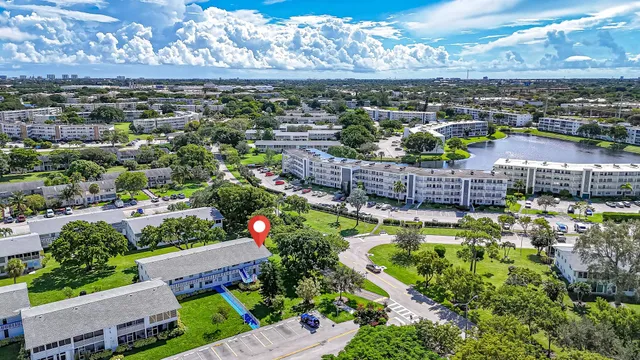 a view of a city with a lot of flower plants and wooden fence